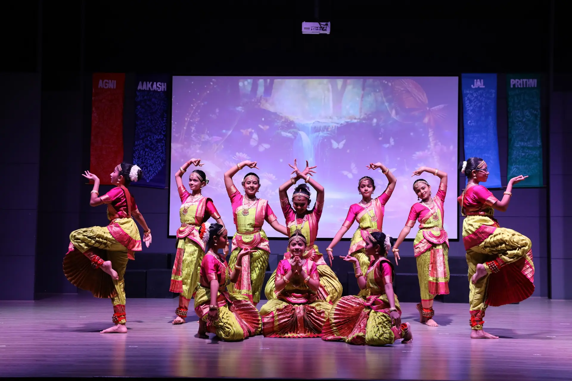 Students performing classical dance on stage