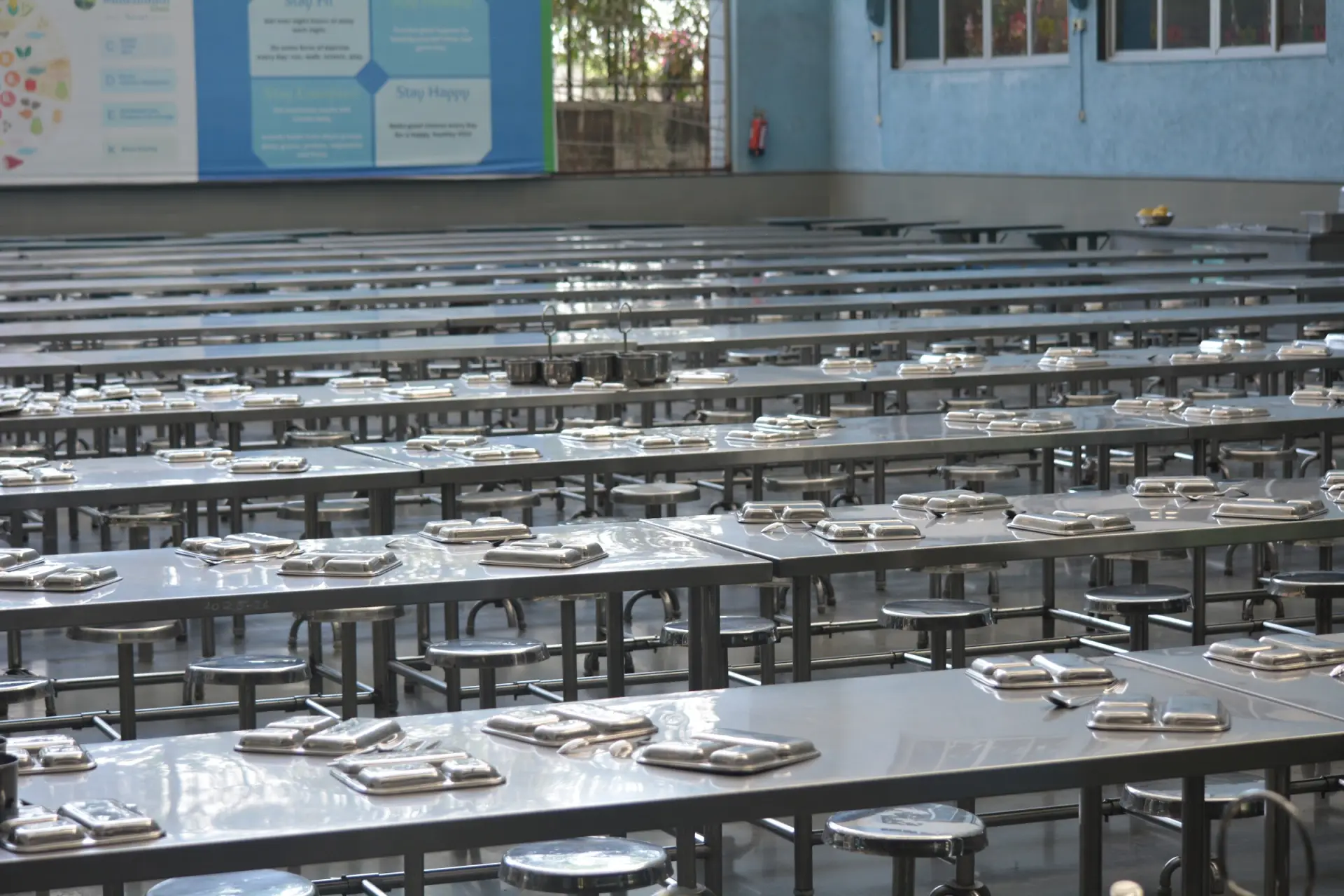 The school dining hall, with tables laid for a meal