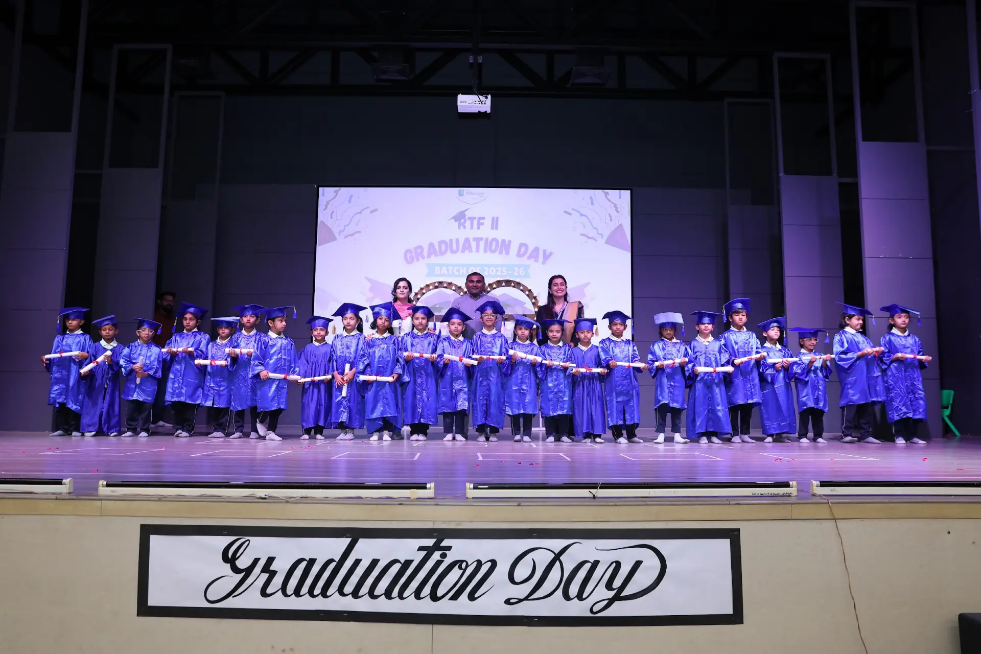 Young graduates on stage at Graduation Day