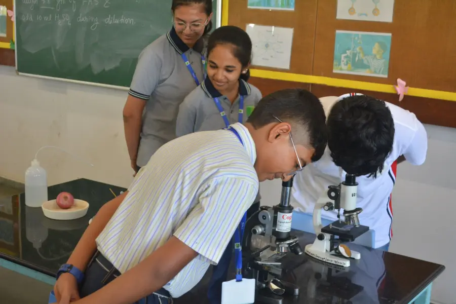 A student looks through a microscope
