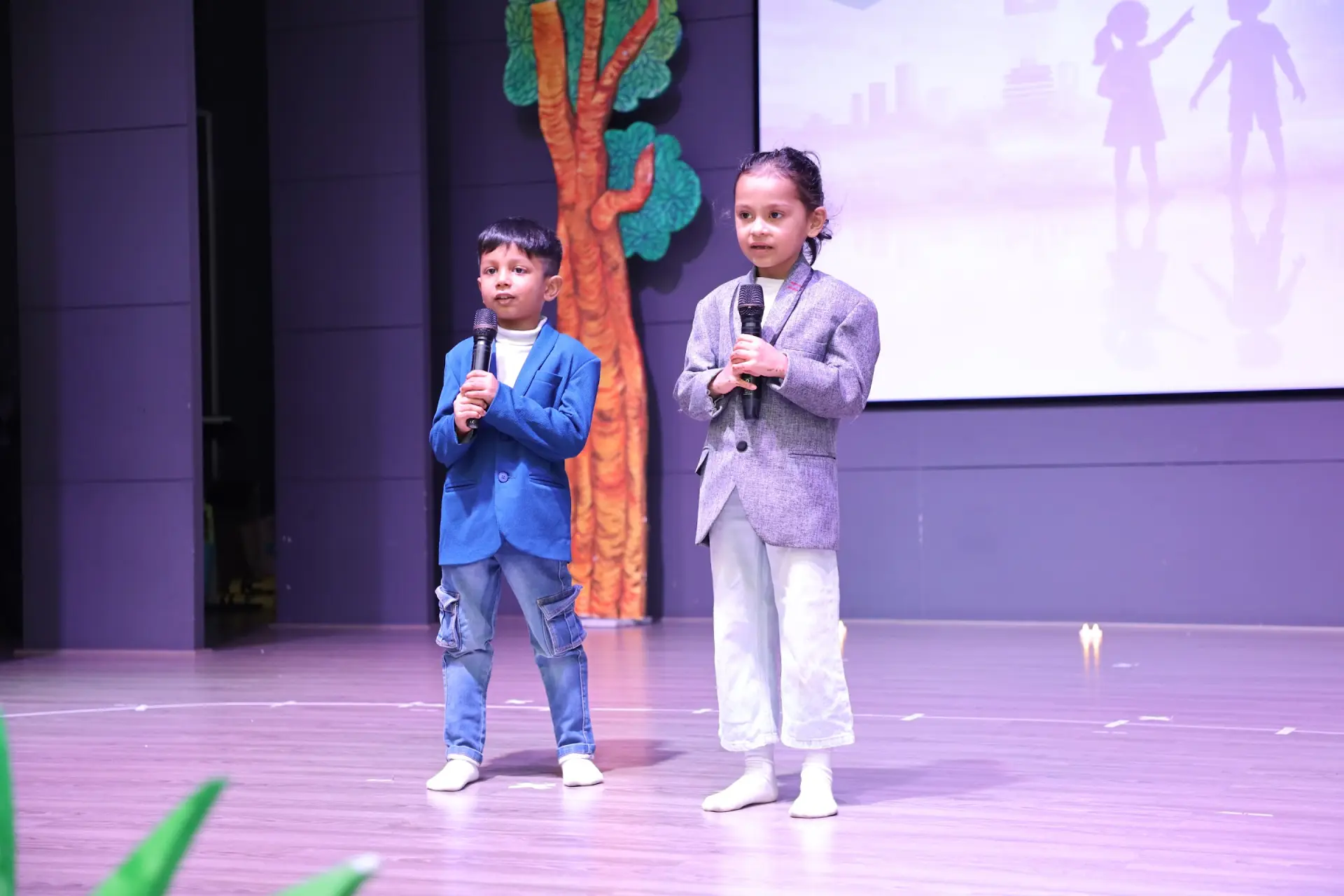 Young students speaking on stage